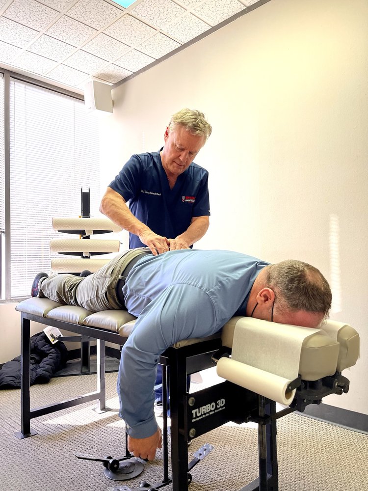 Dr. Terry Smedstad performing hands-on treatment on a patient using a Turbo 3D treatment table